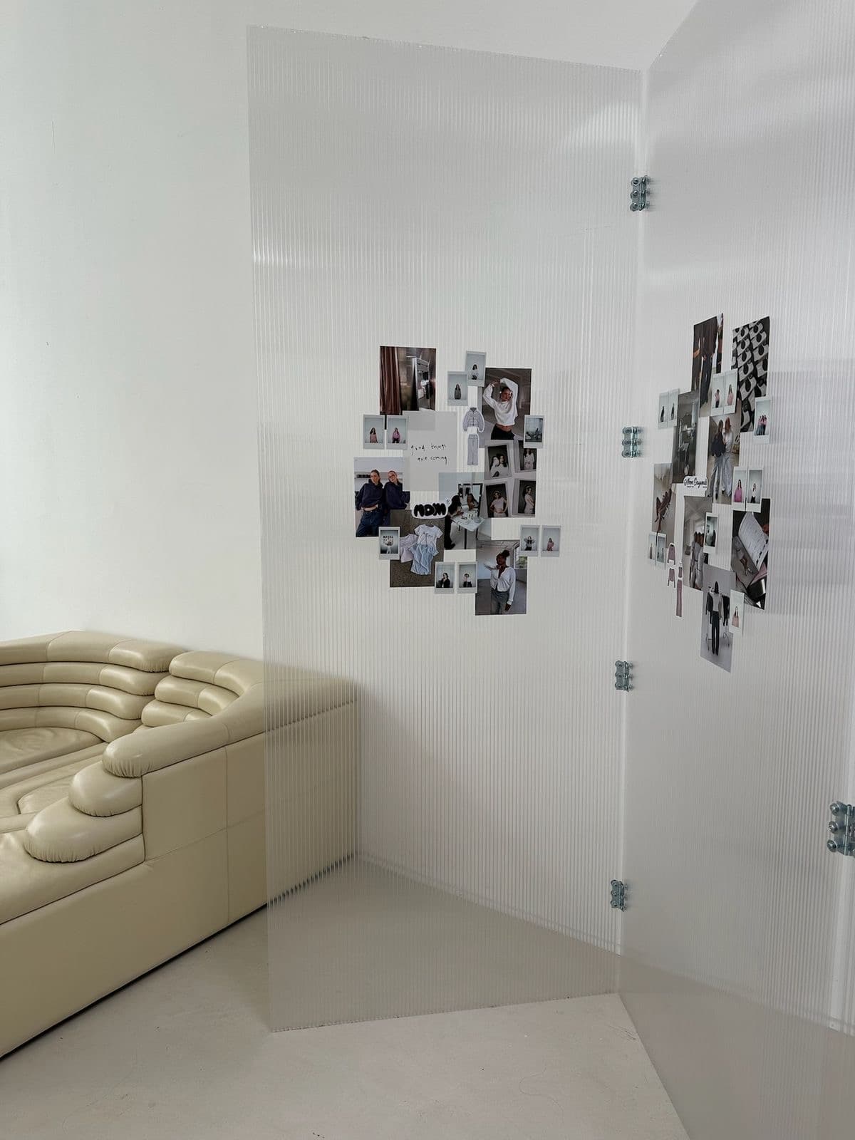A translucent room divider collaged with small polaroid photographs
