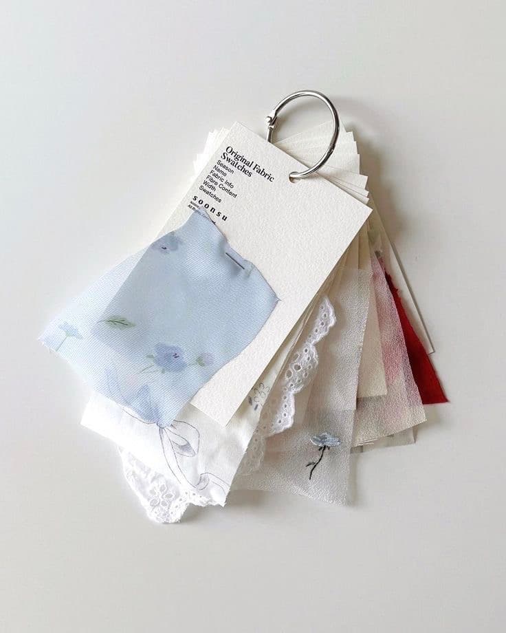 A ring-bound book of original fabric swatches