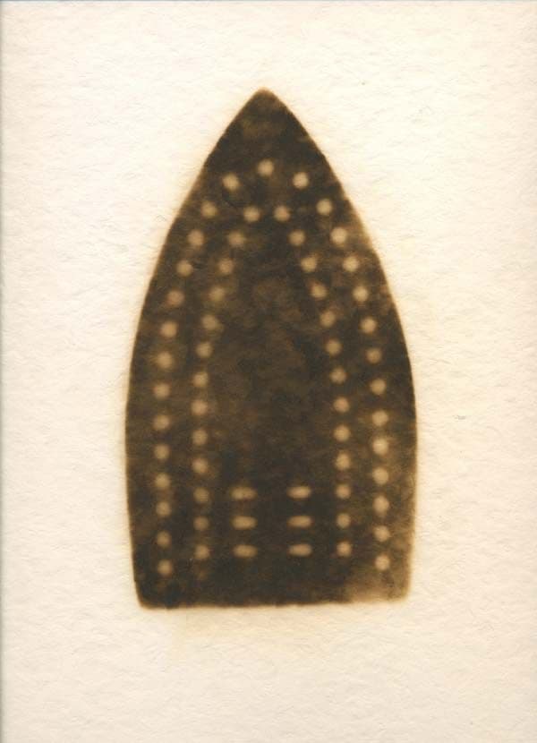 A sepia photogram of a clothes iron, like an X-ray on textured paper